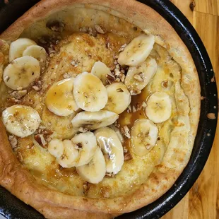 Dutch baby with banana, pecan caramel sauce
