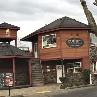 the outside of a restaurant with a clock tower