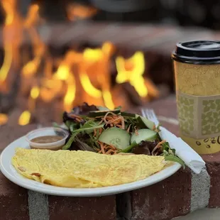 a plate of food and a cup of coffee