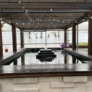 a wooden bench and a water feature