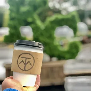 a person holding a cup of coffee