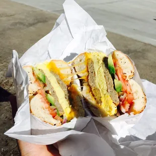 a hand holding a sandwich