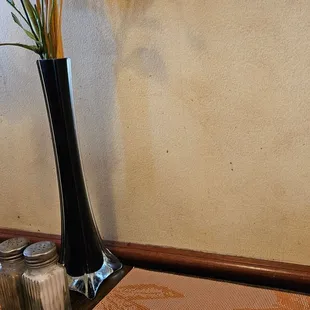 a tall vase with flowers in it