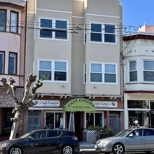 two cars parked in front of a building