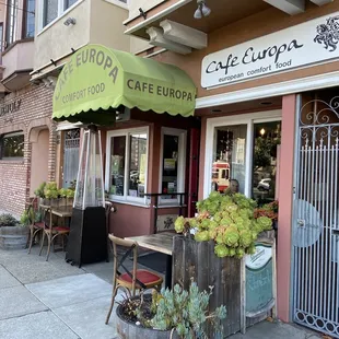 the outside of a restaurant with a green awning