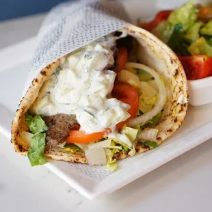 Gyro
housemade beef and lamb slices, lettuce, tomato, onions, feta, and tzatziki sauce with size salad