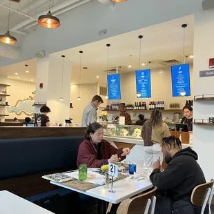 people sitting at tables in a restaurant