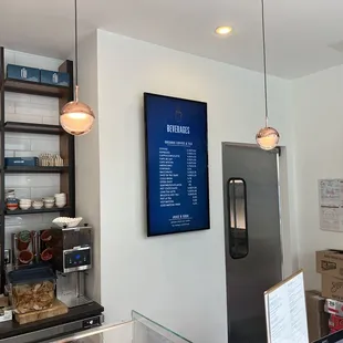 a coffee shop with a menu on the wall