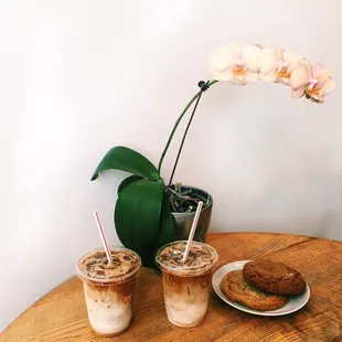 two drinks and a cookie on a table