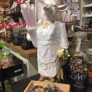 a statue of a sheep holding a tray of chocolates