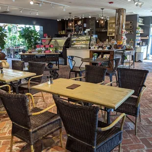 Small little cafe with lots of tables (more outside this photo frame) and even a fireplace