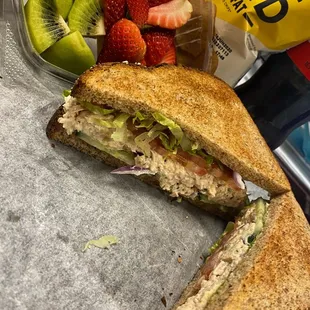 Tuna salad on whole wheat with mayo, lettuce, tomato, onion and cucumbers.