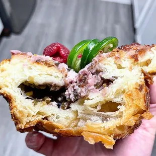 a hand holding a pastry