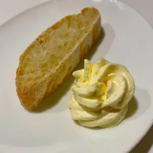 a piece of bread and butter on a plate