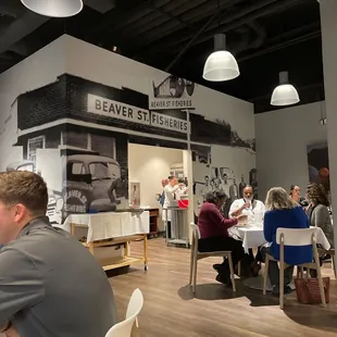 people sitting at tables in a restaurant