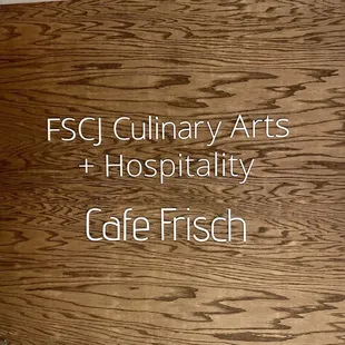 a wooden sign with the words esc culinary arts and hospitality cafe frisch