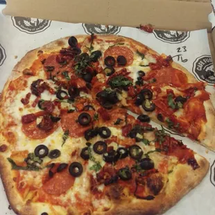 Pepperoni, basil, black olive, sundried tomatoes, with red sauce, half mozzarrela, half parmesan cheese.