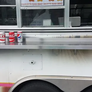 a food truck with soda cans on the side