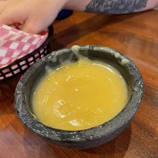 a person dipping a bowl of soup