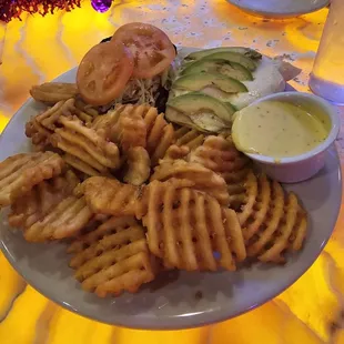 a plate of waffle fries and a sandwich