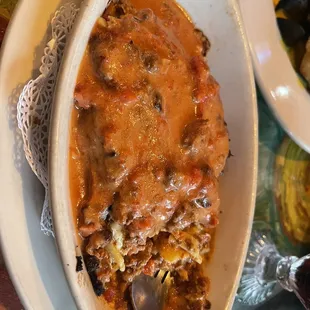 Lasagna Bolognese after they sauced it. They put pink sauce on it and no cheese