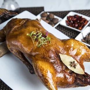 a roasting chicken on a white plate