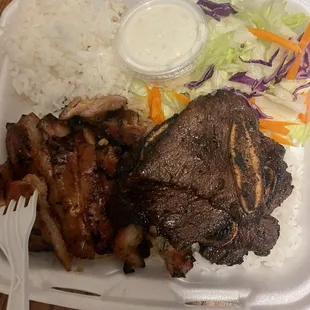 a tray of food with meat and rice