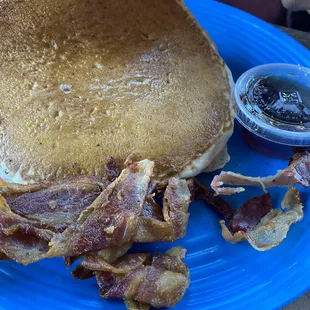 a plate of bacon and pancakes
