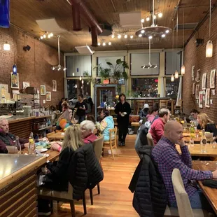 people sitting at tables in a restaurant