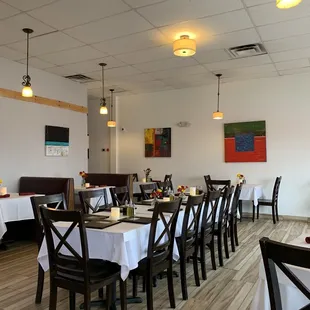 tables and chairs with white tablecloths
