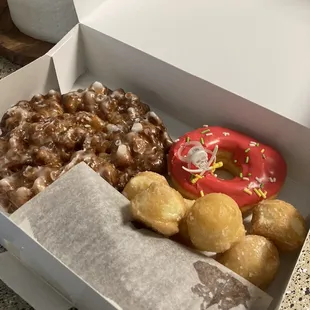 Apple fritter, strawberry Halloween donut, donut holes &amp; chocolate eclaire with Bavarian cream