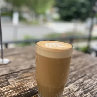 a cup of coffee on a wooden table