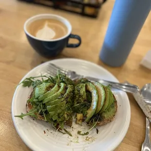 Halved avocado toast on multigrain bread
