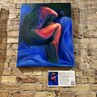 a brick wall with a painting on it