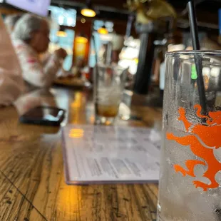  a glass of water with a lion on it