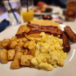 Two fresh eggs, two buttermilk pancakes, two strips of bacon, sausage &amp; breakfast potatoes