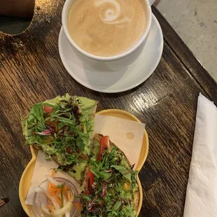 a cup of cappuccino and a sandwich