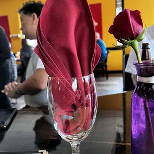 a red rose in a wine glass