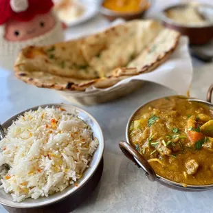 a plate of rice and a bowl of curry