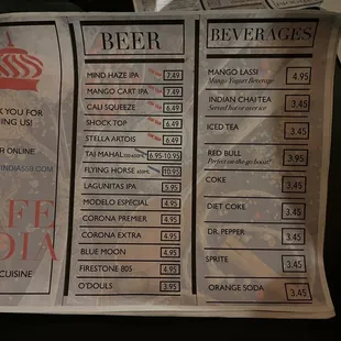 a hand holding a beer menu