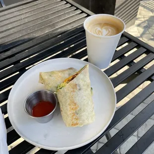 Latte and breakfast burrito on the nice outdoor table