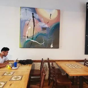 Local art on walls. Good salads &amp; sandwiches (yummy lox bagel). Despite open doors &amp; windows, a lot of flies flying about. Chill spot