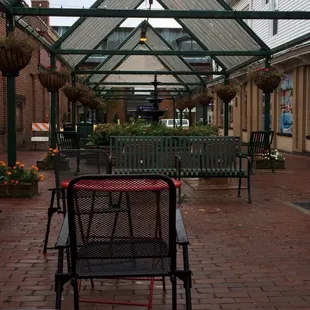 a patio area with tables and chairs