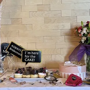 a table with a cake and balloons