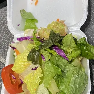 a salad in a styrofoam container