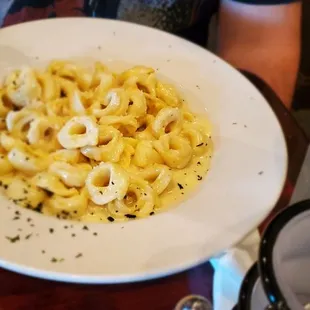 a plate of pasta and a glass of water