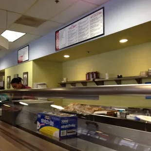 a woman behind the counter at a restaurant