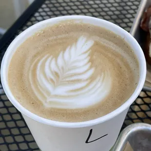a cup of cappuccino and a donut