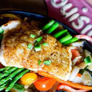 a skillet of chicken and vegetables