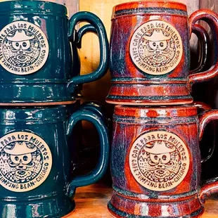 three coffee mugs on a shelf